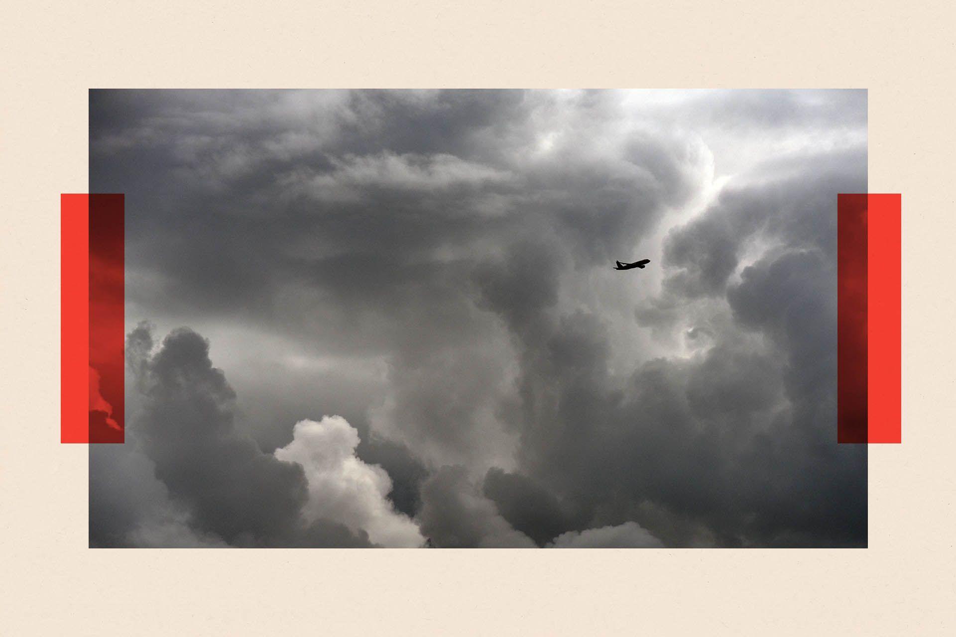 A distant shot of a plane flying through the clouds