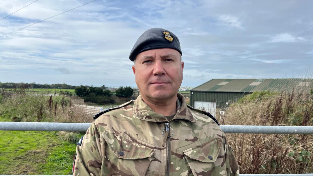 Captain Gez Currie, Station Commander of RAF Valley, wearing camouflage uniform and a hat.