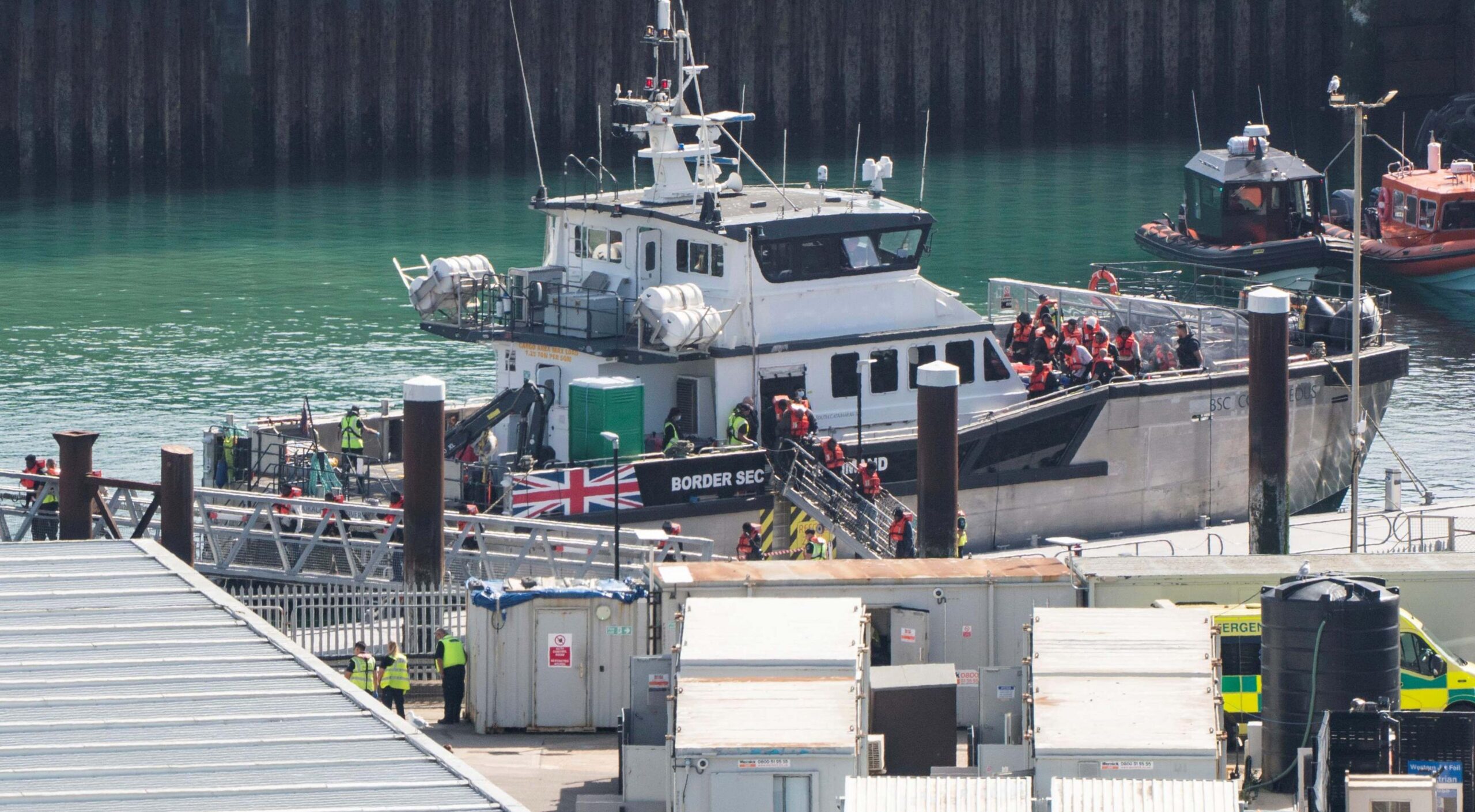 A group of people thought to be migrants are brought in to the Border Security Command compound in Dover, Kent, from a Border Security Command vessel following a small boat incident in the Channel. Picture date: Monday September 21, 2026.