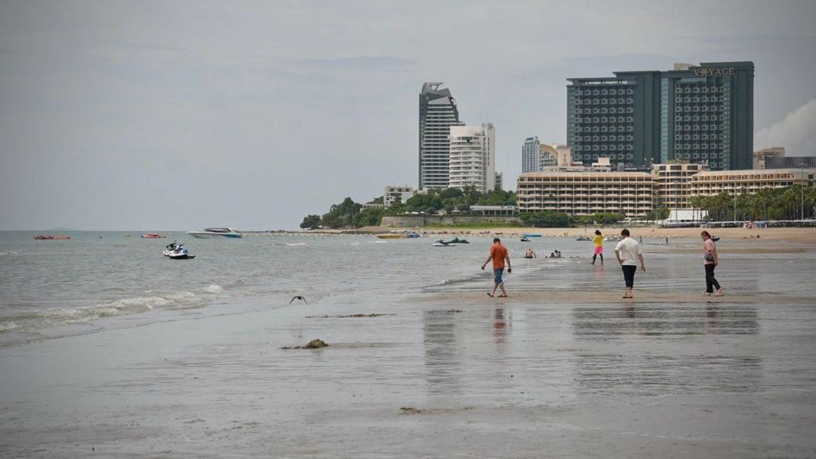 People walking on a beach in Pattaya