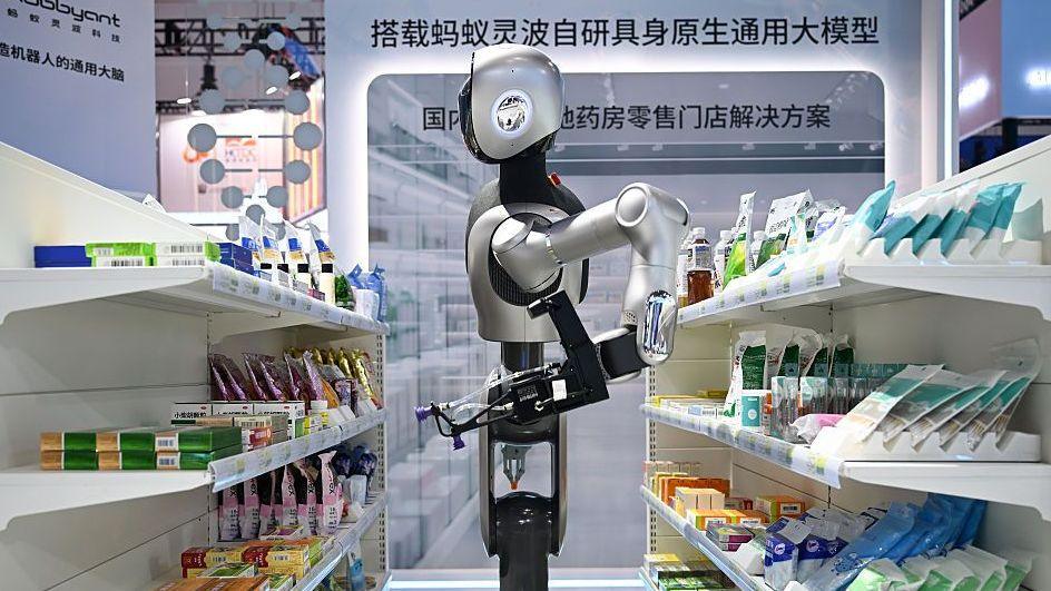 A pharmacy robot organises packs of medicines in a mock-up shop.