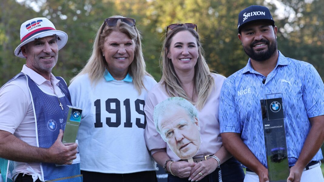 JJ Spaun poses for a photo with his wife and caddie