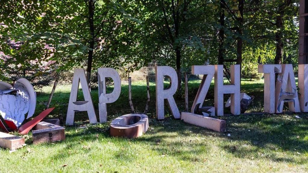 A damaged sign outside the Zaporizhstal steelworks has letters missing