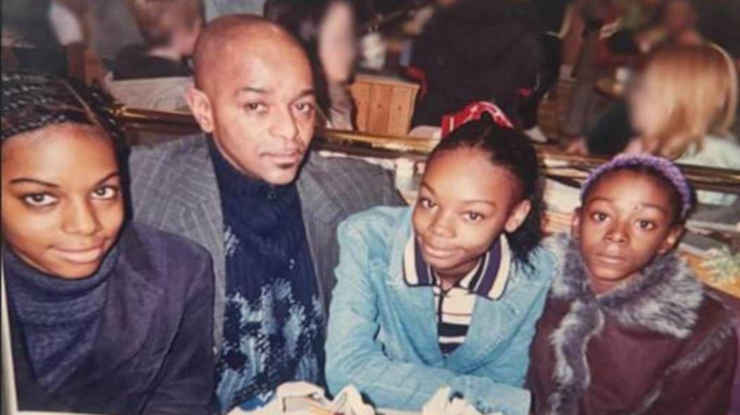The three sisters, seen as teenagers, and their father sit together at a restaurant table, from left to right, Jane Adetoro, Joseph, Christina Walters and Rebecca Walters.