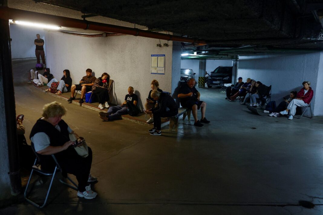 People take shelter inside an underground parking during Russian missile and drone strikes, amid Russia's attack on Ukraine, in Kyiv, Ukraine August 20, 2026.