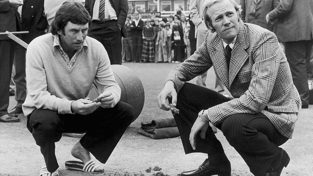 Australia's Ian Chappell (left) and England captain Tony Greig examine the damaged Headingley wicket in 1975