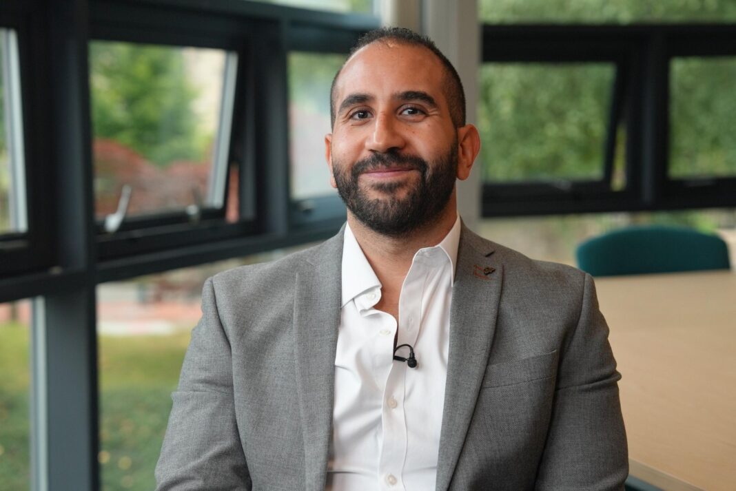 From Amazon retreats to clinical research: The rise of psychedelic therapy Dr Mourad Wahba has a short black beard and hair. He is smiling and wearing a grey blazer and white shirt. He is in an office setting and behind him are windows looking out to greenery.