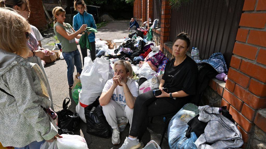 Local residents wait to be evacuated outside of the town of Sudzha on August 8, 2024.