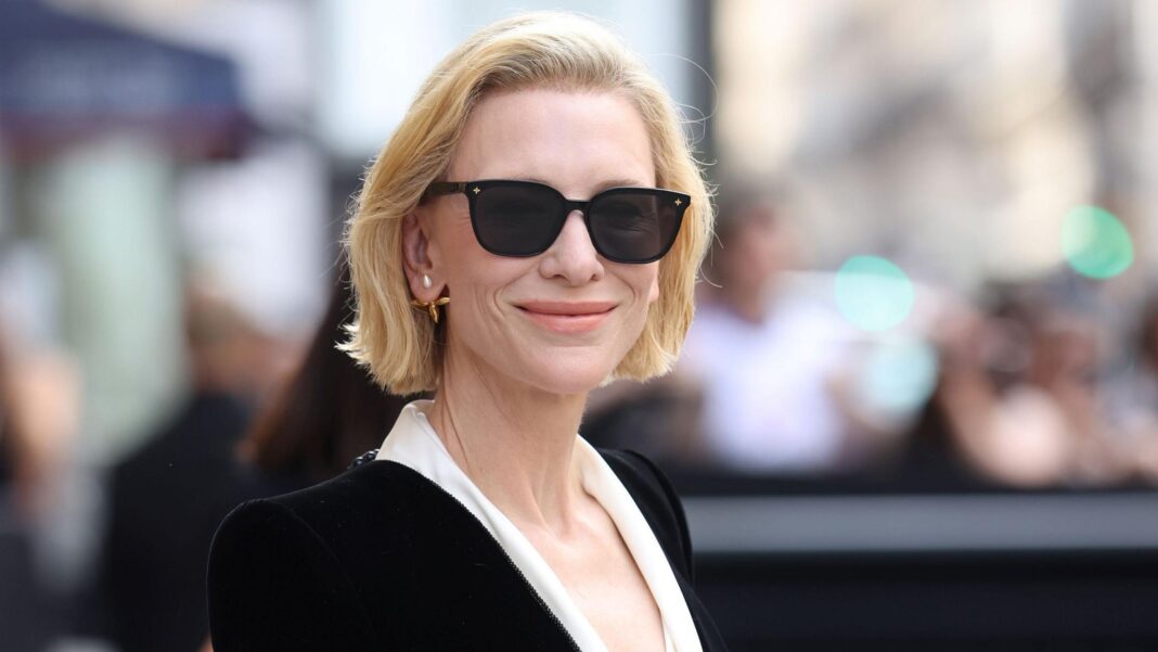 Cate Blanchett wearing a black velvet jacket and dark sunglasses
