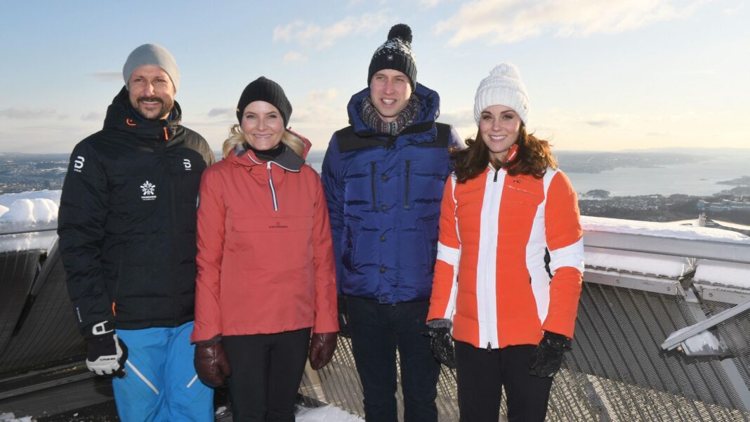 Prince William to attend King Harald’s funeral in Norway Four people stand smiling at the camera in ski jackets and woollen hats. On the left is a man with a goattee beard and next to him is a woman with blonde hair. Next is Prince William wearing a blue ski jacket and pom-pom hat, and Kate wearing a bright orange jacket and white hat. They are standing outside and look to be high-up on a mountain, and in the background is snow and a view.