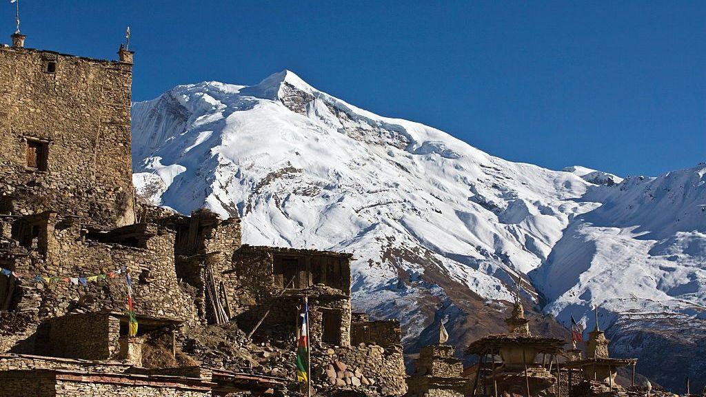 The peaks of Himlung Himal rising over a Neapli village