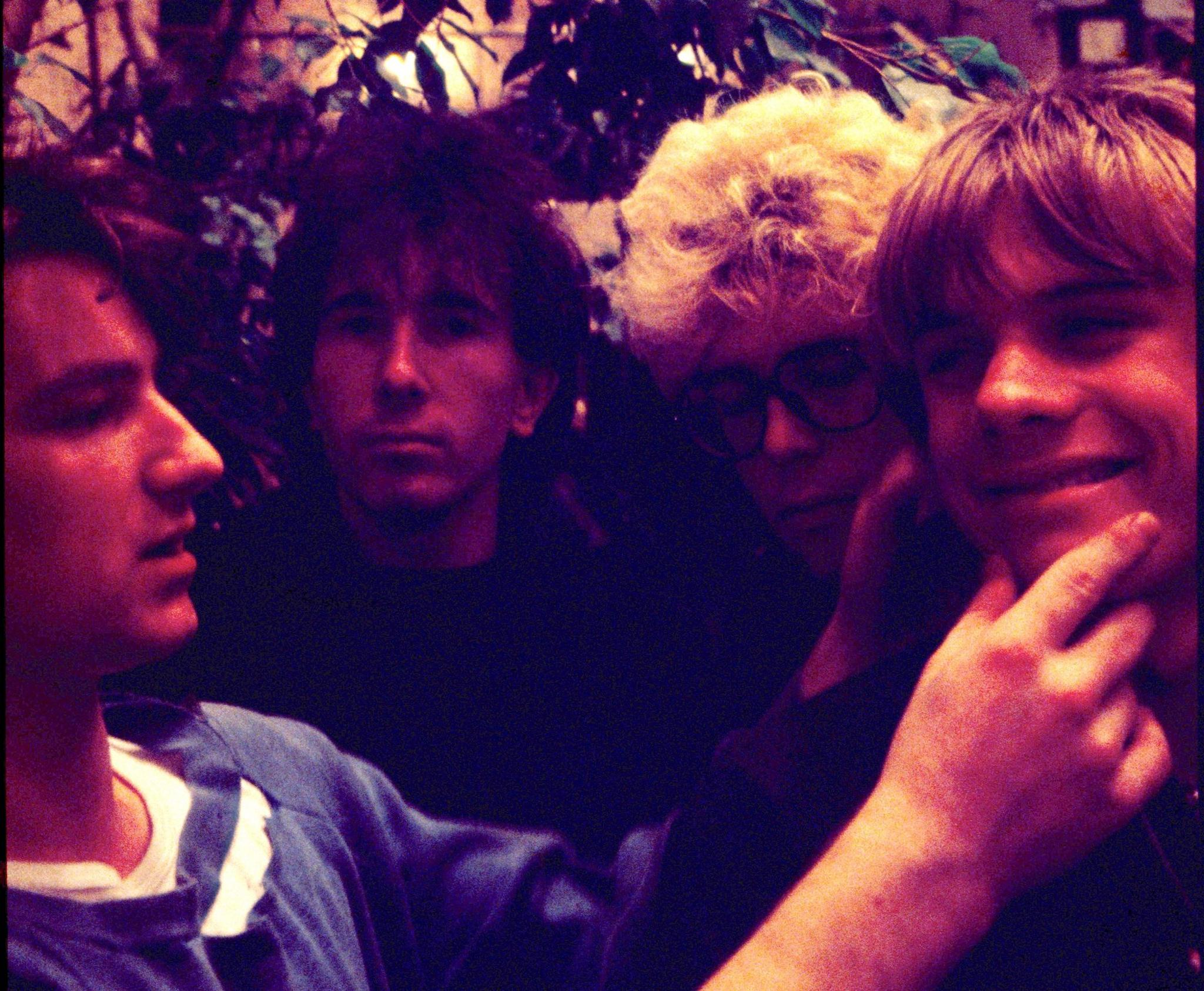 U2 in 1980. Bono is pinching Larry Mullen's cheeks playfully