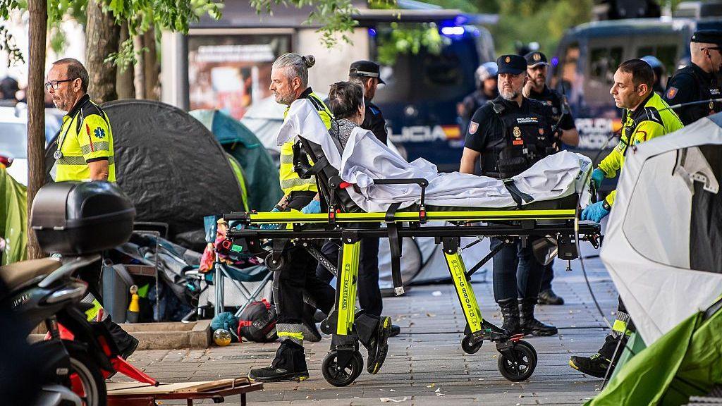 Maricarmen Abascal looks away from the camera as she is pushed on a stretcher by medical personnel after being evicted from her apartment in Madrid on 23 September.