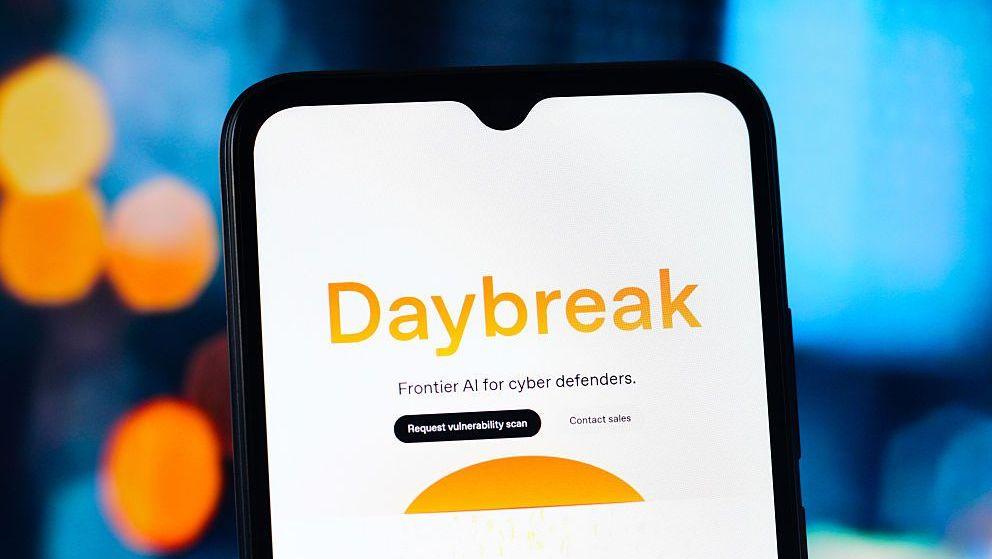 The word Daybreak in orange against a white phone background. Below it says Frontier AI for cyber defenders.