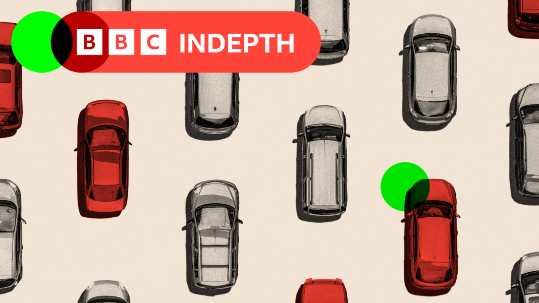 Volkswagen board approves plan to cut another 50,000 jobs A treated image showing an aerial view of cars in grey and others highlighted in red