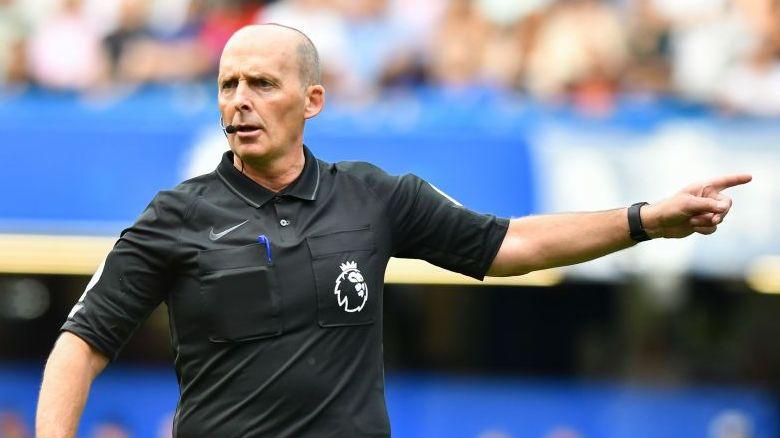 Referee Mike Dean points
