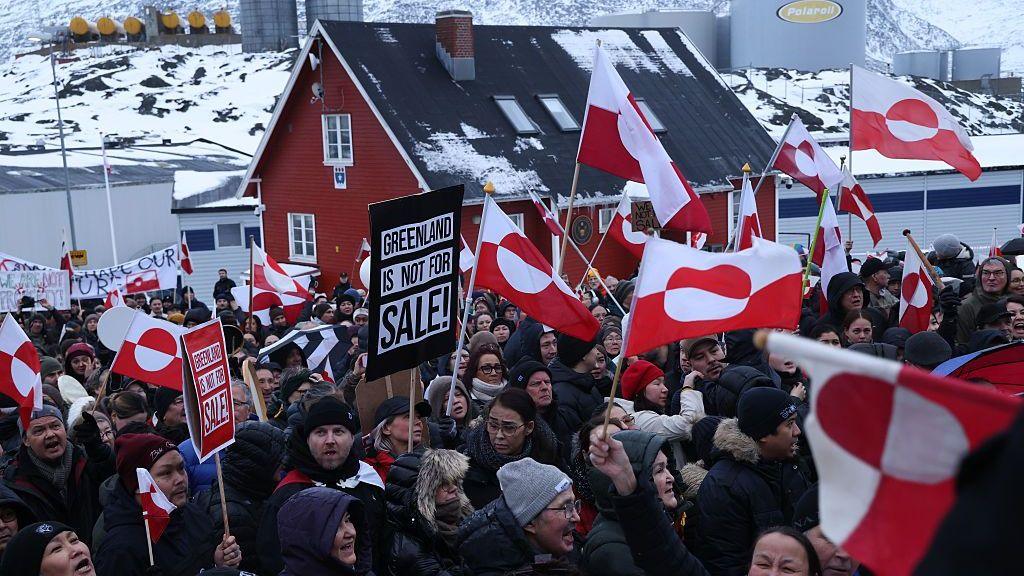 People bear Greenlandic flags as they gather in front of the US consulate in Nuuk, Greenland, in a protest against President Donald Trump's announced intent to acquire Greenland in January 2026