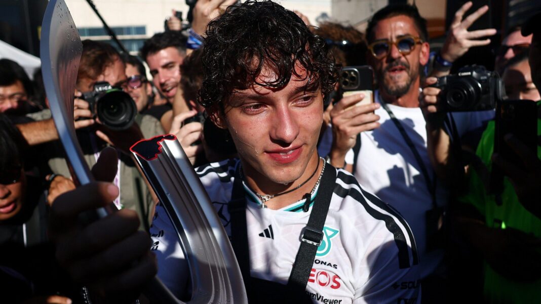 The moment Antonelli knew he had been transformed as an F1 driver Kimi Antonelli surrounded by photographers while holding the winner's trophy after the 2026 Spanish Grand Prix