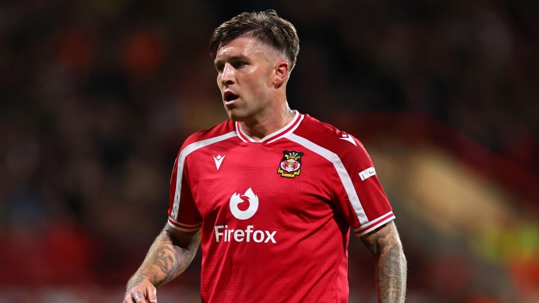 Wrexham defender Cleworth set for two months out Josh Windass in Wrexham's red kit