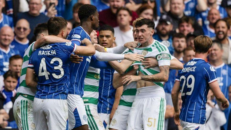 Celtic and Rangers players in a scuffle