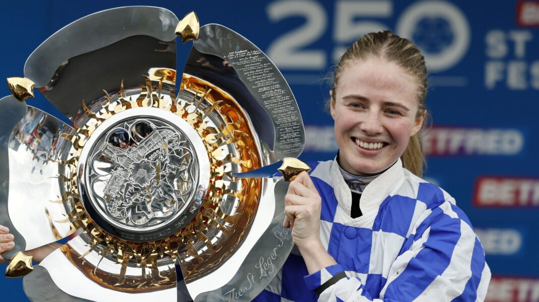 St Leger win has removed Osborne’s fear of failure Saffie Osborne, in blue and white-checked silks, holding a silver trophy to her right