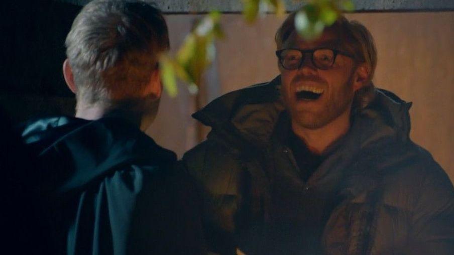 Rob Beckett laughing as he faces James Acaster