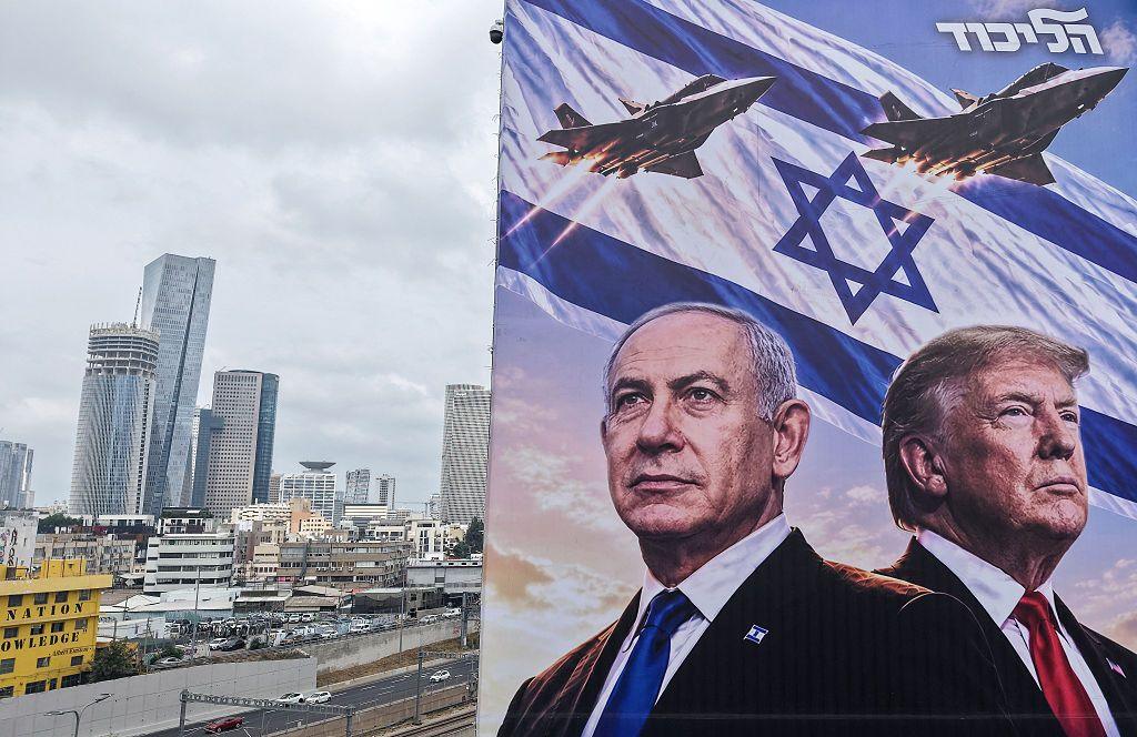 A campaign poster displays Netanyahu and Trump.