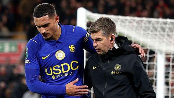 Maxence Lacroix walks off injured helped by a Chelsea physiotherapist