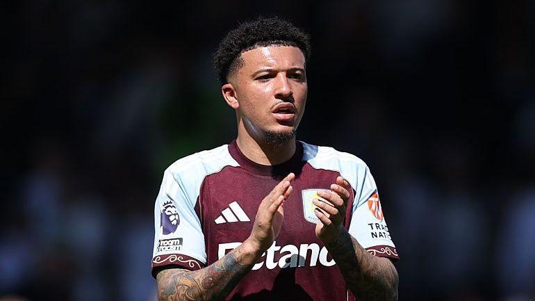 Jadon Sancho wearing an Aston Villa shirt