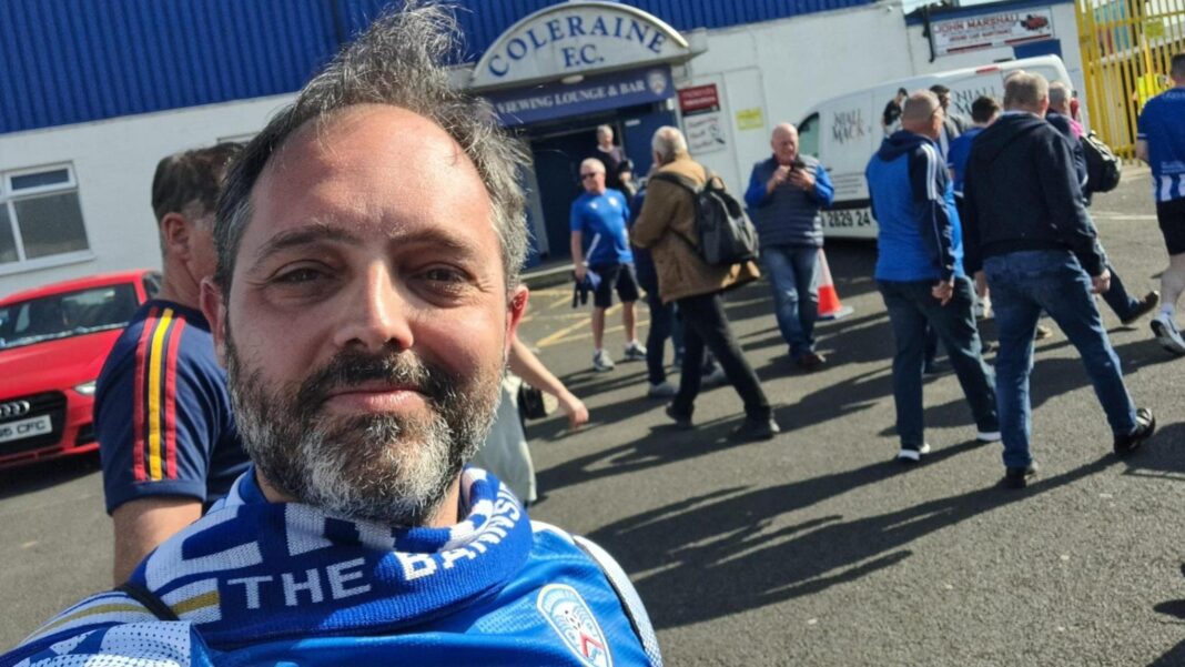 How a folk band, football club and Fifa 11 came together for an unlikely terrace anthem A man smiling at the camera, he is wearing a blue and white scarf and top, he has dark hair and beard