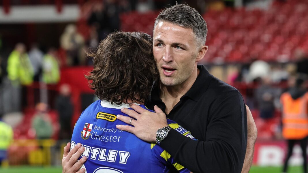 Sam Burgess hugs Warrington player James Bentley after their defeat by Wakefield Trinity in the Grand Final