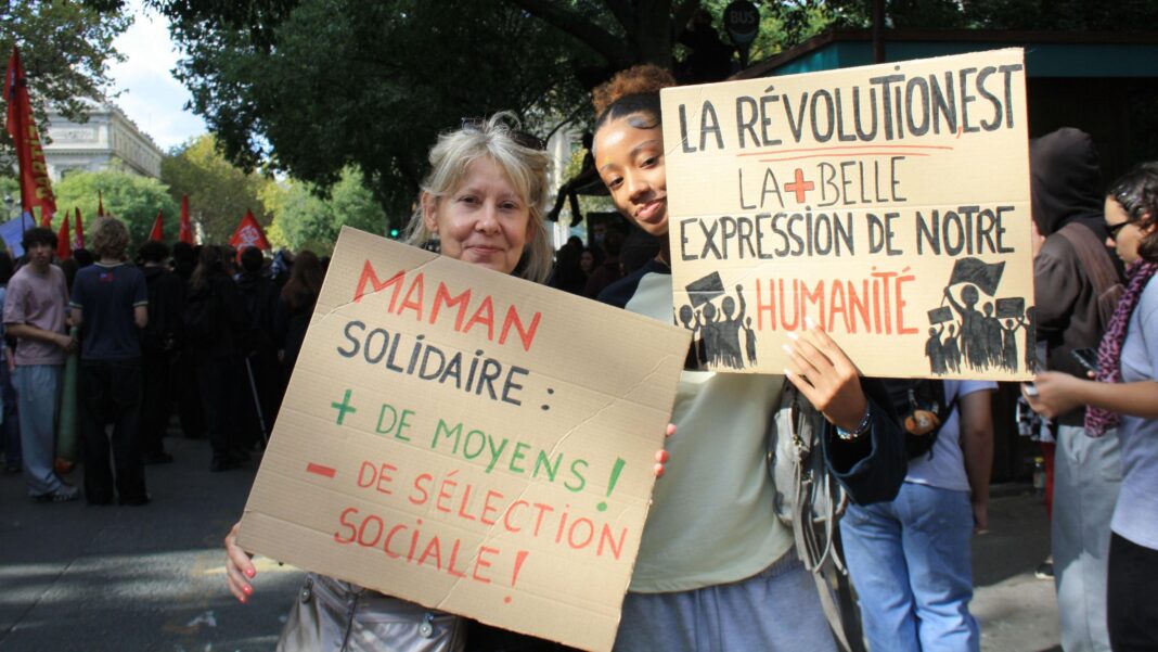 Are student protests being manipulated ahead of France’s presidential election? A young woman and her mother (to the left) stand together holding placards in French