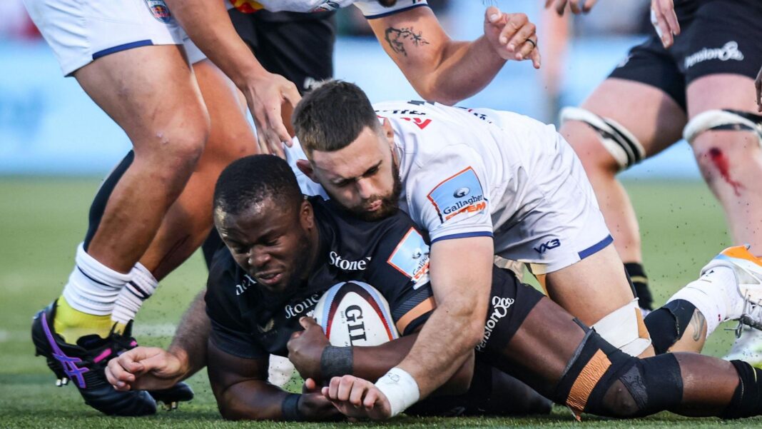 Rotimi Segun has the ball on the floor with Newcastle forward Max Hicks on top of him