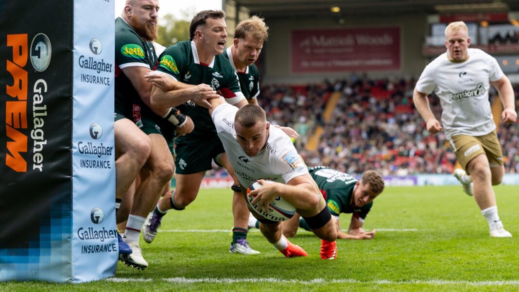 Ben Earl of Saracens, in white kit, dives near to a post to score his side's fourth try in their win at Leicester Tigers