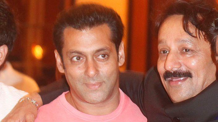 Congress MLA Baba Siddique, left, wearing a black suit, has his arm around with Bollywood actor Salman Khan, smiling while wearing a pink T-shirt