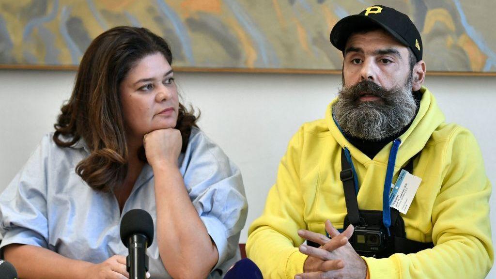 A picture from 2022 of French member of parliament for La France Insoumise (LFI) Raquel Garrido (L) with Jérôme Rodrigues (R) wearing yellow at the National Assembly.