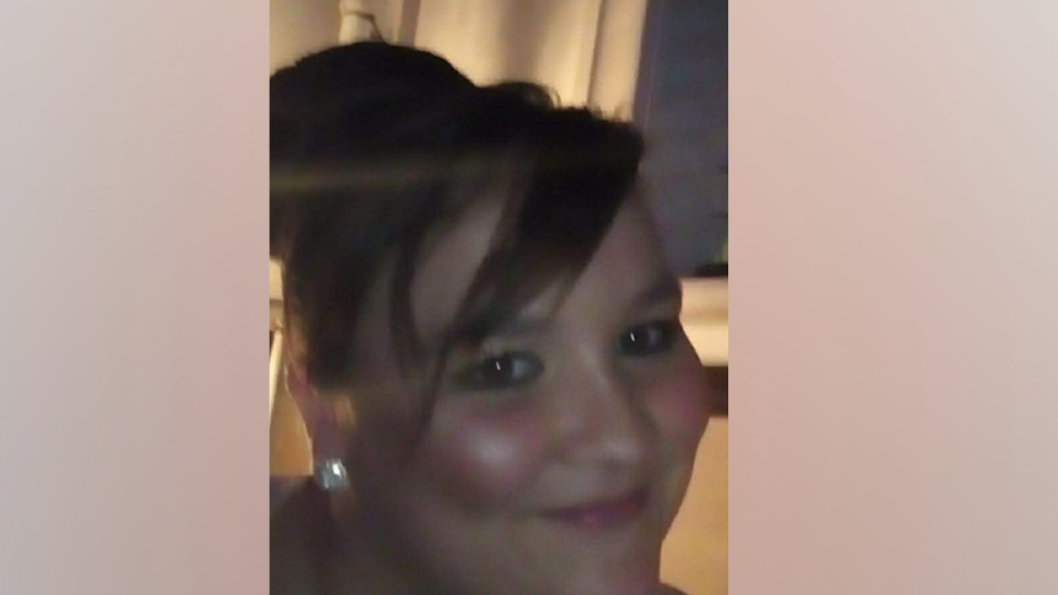 Police issued image of Carolann Barraclough. She is smiling a the camera and has long dark hair piled up on her head.