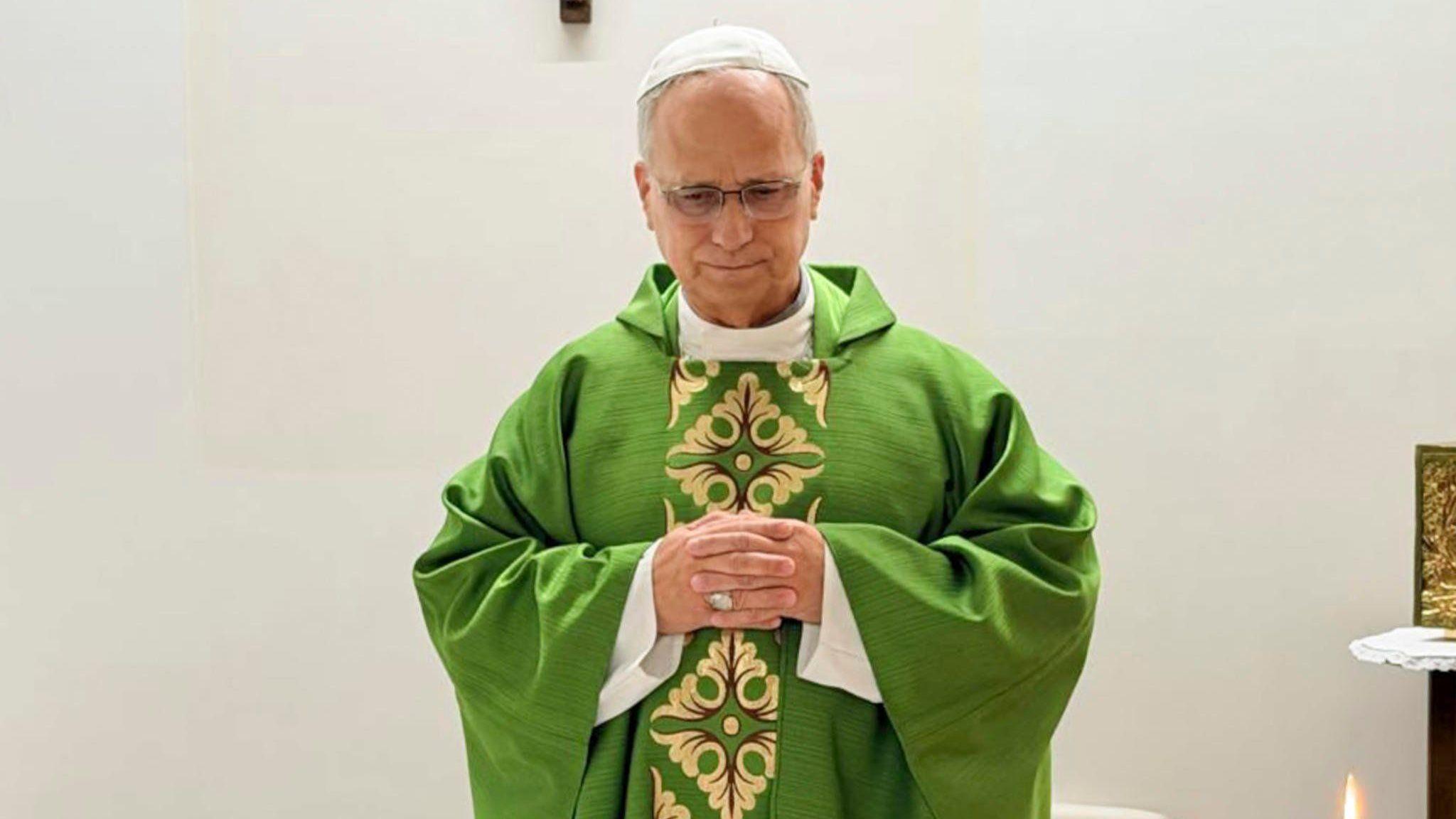 Pope Leo holds his hands in prayer, celebrating a mass