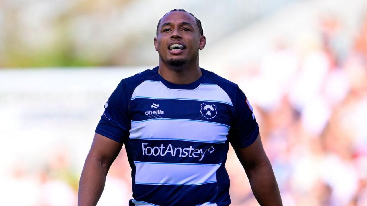 Gabriel Oghre walking on the pitch