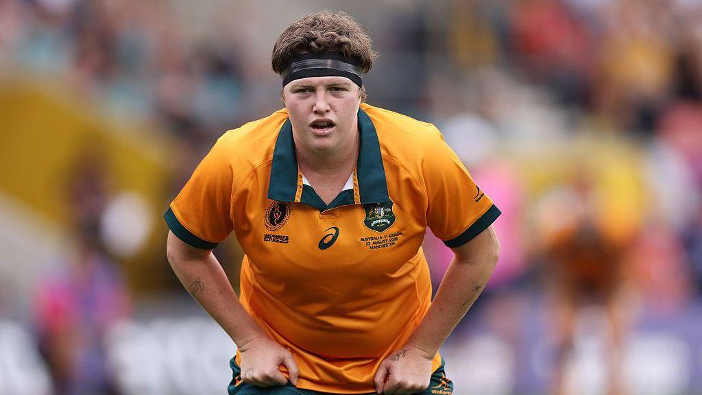 Bridie O'Gorman stands slightly bent forward, with her hands on her hips as she looks straight ahead during a World Cup game for Australia in 2025.