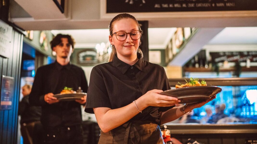 Tax on banks, energy bill help and minimum wage rise – what could be in the Budget? Young restaurant staff carrying freshly prepared meals through a busy pub restaurant