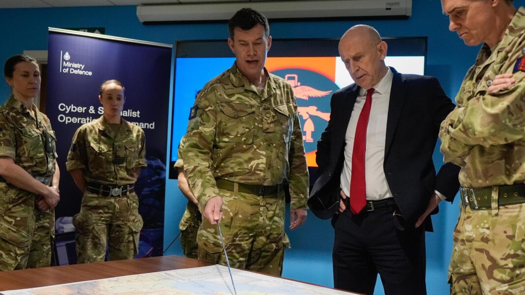 Who is Chancellor John Healey? Labour veteran who quit as defence secretary Defence Secretary John Healey is given a briefing as he meets military personnel during a visit to the Permanent Joint Headquarters in Northwood, London. He is wearing a suit and stands alongside military personnel wearing camouflage uniform, with one pointing at a map.