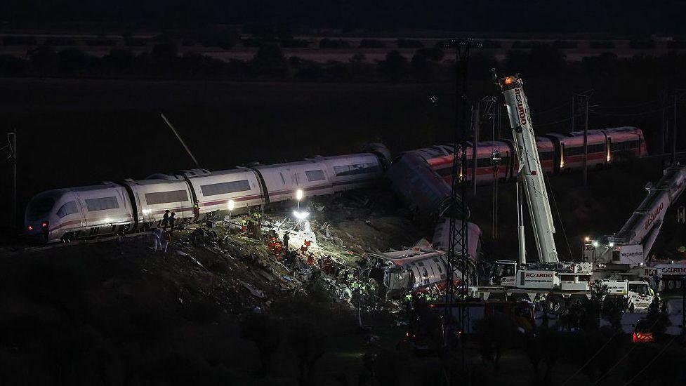 Emergency services personnel are working with torches at the scene of the incident, on 28 October, 2026 in Urda, Toledo, Castilla-La Mancha, Spain.