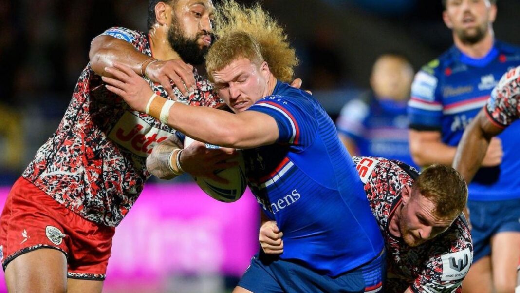 ‘You could be legends’ – inside unfancied Wakefield’s rapid ascent Wakefield prop Caius Faatili's mullet flails in the face of Isaac Liu as he braces being tackled by Liu and Jack Hughes both high and low.