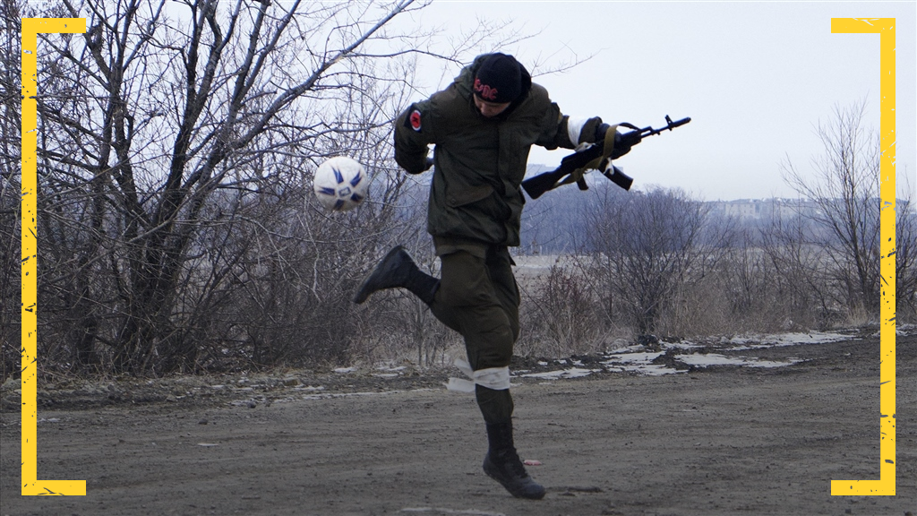 FEBRUARY 19 2015 Pro-Russian rebels play with a football on the road to Debaltseve on February 19, 2015 in Vuglegirsk near Debaltseve, Ukraine. According to reports, Debaltseve is largely under the control of rebel fighters, after Ukranian forces withdrew yesterday.