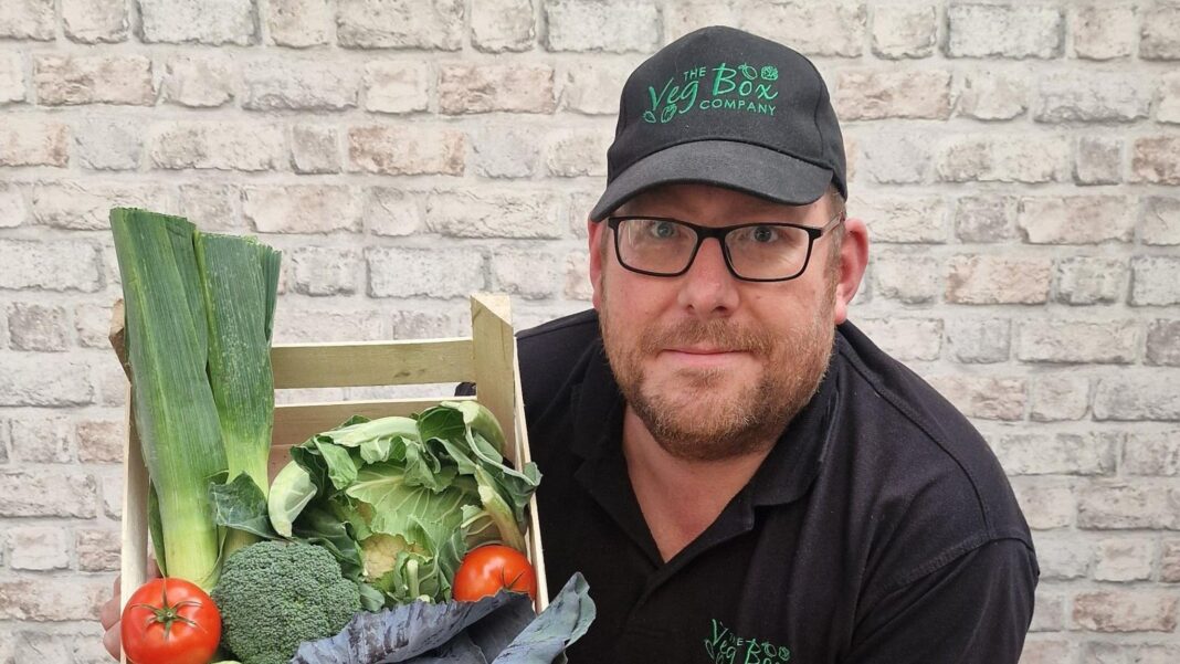 Google says services recovering after cloud outage hits UK banks and websites Guy Baybutt, wearing a black cap and t-shirt emblazoned with the logo of his business "The Veg Box", holds up a box of leafy green vegetables and tomatoes.