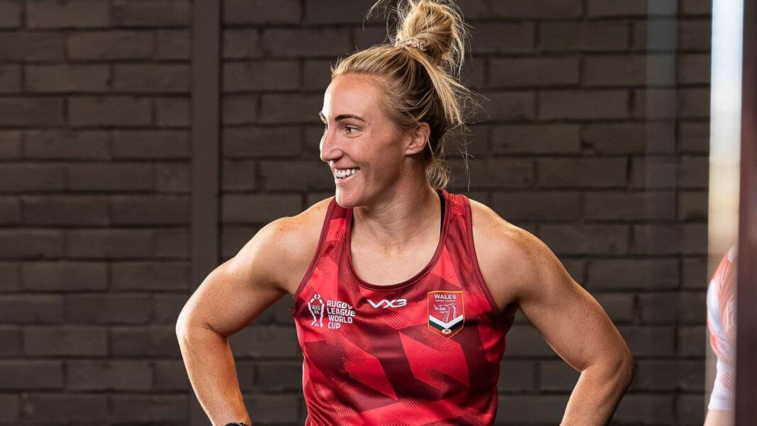 Wales aim to punch above weight on World Cup debut Bethan Dainton in red vest smiles in the gym in front of a brick wall
