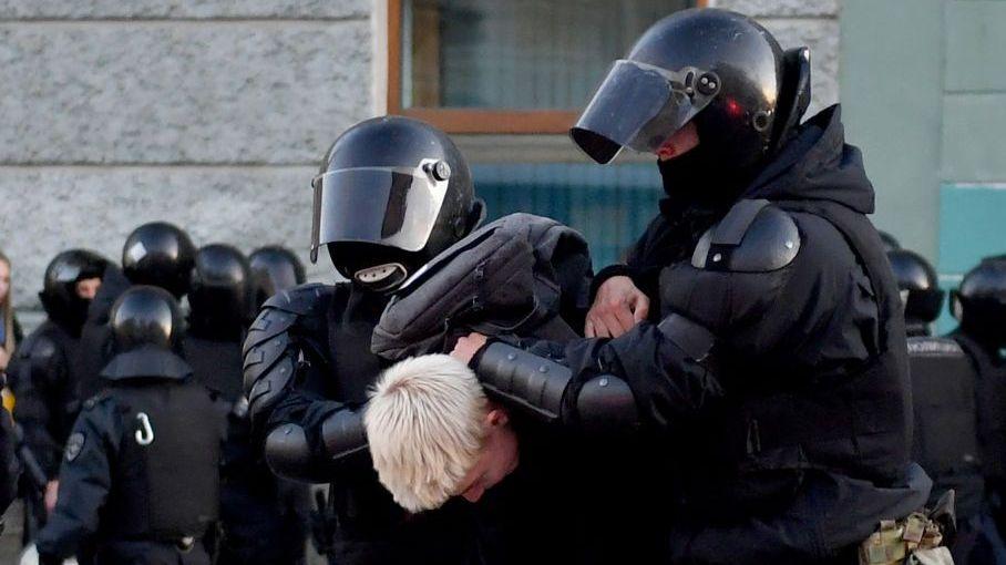 A 2022 picture of police hold a person with blond hair during a protest in Moscow against the war in Ukraine