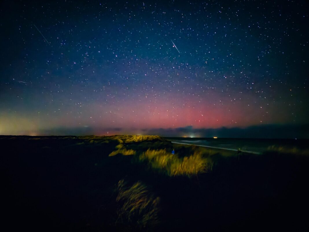 An image of the sky in Winterton-on-Sea, Norfolk, on 9 October during the evening. A pink haze can be seen towards the horizon.