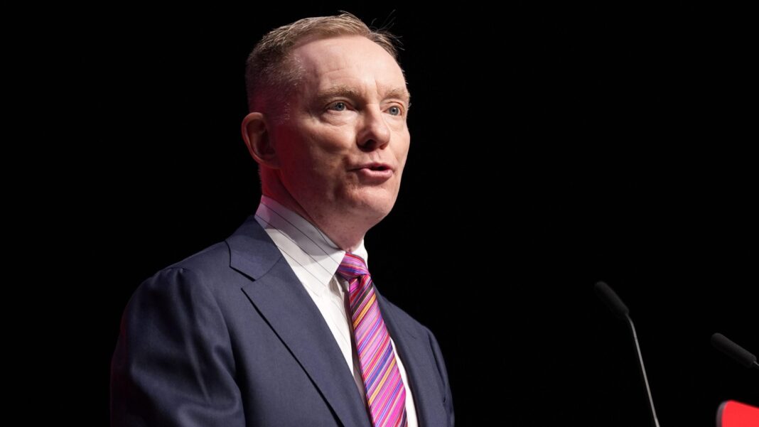 Drumcree parade ban was in interests of peace, says Bryant Sir Chris is talking into a mic on a stage. He's wearing a navy suit with a white shirt and stripy tie. The background is dark.